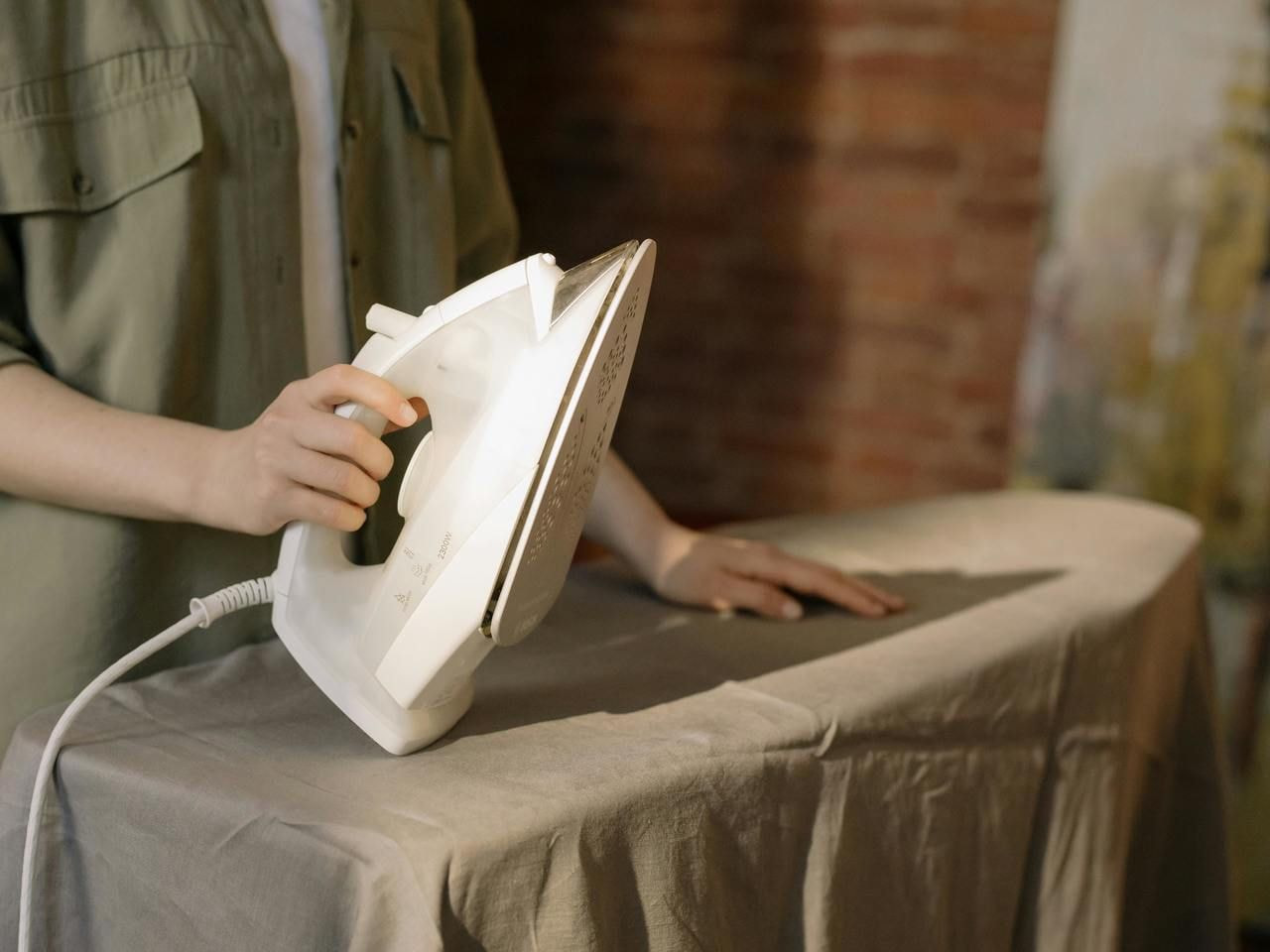 A person ironing some fabric